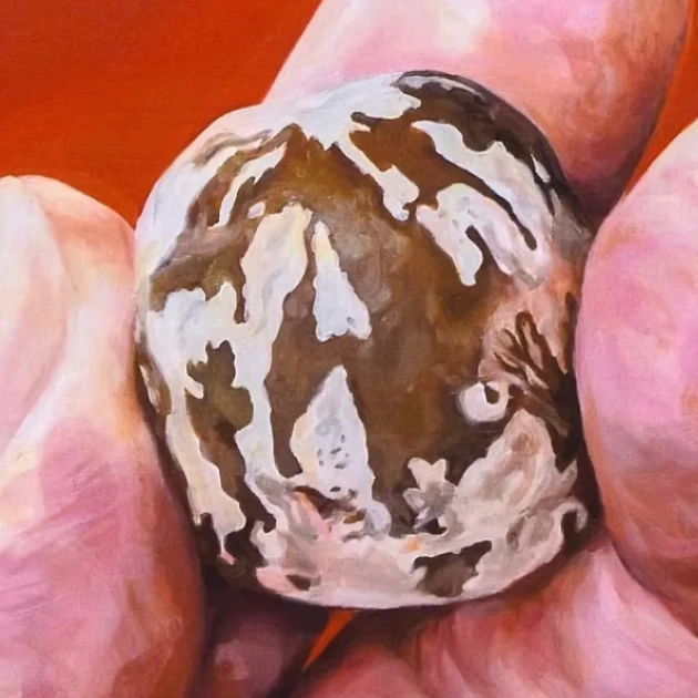 A painting of fingers holding a rubber seed.